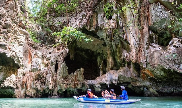 family paddling together in big kayak